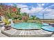 Backyard pool area, partially drained, surrounded by wooden deck and landscaping at 21320 Paradise Way, Eustis, FL 32736