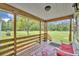 A cozy porch with views of the lush and well-maintained front yard at 21320 Paradise Way, Eustis, FL 32736