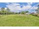 Expansive property featuring large green field, landscaping, multiple structures and treeline at 21320 Paradise Way, Eustis, FL 32736