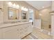Bathroom featuring dual sinks, white cabinets, and glass walk-in shower at 2163 County Road 243F, Wildwood, FL 34785