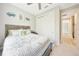 Inviting bedroom features a comfortable bed, closet, bedside table, ceiling fan, and coastal decorations at 2163 County Road 243F, Wildwood, FL 34785