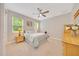 Bedroom with neutral walls, ceiling fan, two windows, and carpet flooring at 2163 County Road 243F, Wildwood, FL 34785