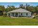 Charming single-story home with a well-manicured lawn, lush landscaping, and inviting curb appeal at 2163 County Road 243F, Wildwood, FL 34785