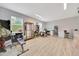 Large, well-lit garage featuring laminate flooring and space for storage and a work or exercise area at 2163 County Road 243F, Wildwood, FL 34785