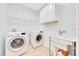 Laundry room with washer, dryer, sink, and overhead shelving at 2163 County Road 243F, Wildwood, FL 34785