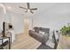 The living room offers a kitchenette, a ceiling fan and natural light streaming in through a window at 2163 County Road 243F, Wildwood, FL 34785