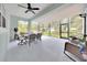 A covered patio with a table and chairs offers a serene space to dine al fresco and enjoy outdoor views at 2163 County Road 243F, Wildwood, FL 34785