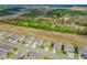 Aerial view showcasing houses in the neighborhood with lush green landscape and a highway in the background at 2350 Gold Dust Dr, Clermont, FL 34715
