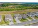 Aerial view showcasing houses in the neighborhood with lush green landscape and roads in an orderly layout at 2350 Gold Dust Dr, Clermont, FL 34715