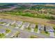 Aerial view showcasing houses in the neighborhood with lush green landscape and a highway in the background at 2350 Gold Dust Dr, Clermont, FL 34715