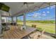 Relaxing covered outdoor living space with ceiling fans and a great view of the manicured green lawn at 2350 Gold Dust Dr, Clermont, FL 34715