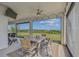 This covered porch features views of the manicured yard, and the area is great for outdoor dining or entertaining at 2350 Gold Dust Dr, Clermont, FL 34715