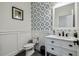 Stylish half-bathroom with patterned wallpaper, vanity with marble countertop, and modern fixtures at 2350 Gold Dust Dr, Clermont, FL 34715