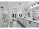 Bright and modern bathroom featuring dual vanities, quartz countertops and glass enclosed shower at 2350 Gold Dust Dr, Clermont, FL 34715