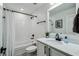Bright bathroom features a shower-tub combination and a vanity with modern fixtures and hardware at 2350 Gold Dust Dr, Clermont, FL 34715