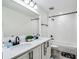Bright bathroom featuring double sinks, white cabinets, and black fixtures at 2350 Gold Dust Dr, Clermont, FL 34715