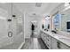 Modern bathroom features dual sinks, quartz countertops, and a large glass-enclosed shower at 2350 Gold Dust Dr, Clermont, FL 34715