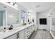 Bathroom boasting a modern vanity with quartz countertops, dual mirrors, and a glass shower at 2350 Gold Dust Dr, Clermont, FL 34715