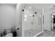 Modern bathroom featuring a glass shower enclosure with white tile and black fixtures at 2350 Gold Dust Dr, Clermont, FL 34715