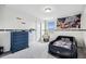 Bedroom showcasing a car-themed bed, gray carpet, and navy dresser against white walls at 2350 Gold Dust Dr, Clermont, FL 34715