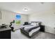 Bedroom featuring a large window, gray carpet, exercise bike, and cozy armchair at 2350 Gold Dust Dr, Clermont, FL 34715