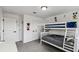 Bright bedroom featuring a bunk bed, light gray carpet, and playful Disney-themed decorations at 2350 Gold Dust Dr, Clermont, FL 34715