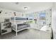 Bright bedroom featuring a bunk bed, light gray carpet, and playful Disney-themed decorations at 2350 Gold Dust Dr, Clermont, FL 34715