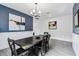 Well-lit dining room showcases a long wood table, wainscoting and a stylish blue accent wall at 2350 Gold Dust Dr, Clermont, FL 34715