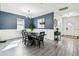 Inviting dining room with wooden table and chairs, elegant chandelier, and blue accent wall at 2350 Gold Dust Dr, Clermont, FL 34715