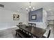 Bright dining room features a modern chandelier, beautiful wainscoting and a stylish blue accent wall at 2350 Gold Dust Dr, Clermont, FL 34715