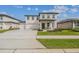 Charming two-story home boasting a covered front porch, a three car garage, and well-manicured landscaping at 2350 Gold Dust Dr, Clermont, FL 34715