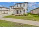 Charming two-story home boasting a covered front porch, a three car garage, and well-manicured landscaping at 2350 Gold Dust Dr, Clermont, FL 34715