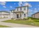 Charming two-story home boasting a covered front porch, a three car garage, and well-manicured landscaping at 2350 Gold Dust Dr, Clermont, FL 34715