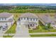 Desirable two-story home featuring a three car garage, lush landscaping, and a charming covered front porch at 2350 Gold Dust Dr, Clermont, FL 34715