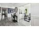 Hallway leading into an office space, neutral colors, with wainscoting and wood-look tile at 2350 Gold Dust Dr, Clermont, FL 34715