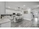 Open kitchen features white cabinets, stainless steel appliances, gray backsplash, and an island with seating at 2350 Gold Dust Dr, Clermont, FL 34715