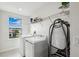 Modern laundry room features a new washer, dryer, and a window with a beautiful neighborhood view at 2350 Gold Dust Dr, Clermont, FL 34715