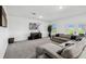 Comfortable living room with a large sectional sofa, entertainment center, and natural light at 2350 Gold Dust Dr, Clermont, FL 34715