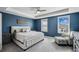 The main bedroom features blue walls, a tray ceiling, and ample natural light at 2350 Gold Dust Dr, Clermont, FL 34715