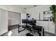 Well-lit office with two monitors, built-in shelving, and view into hallway with neutral colors at 2350 Gold Dust Dr, Clermont, FL 34715