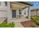 Charming front porch featuring a modern door, lush landscaping, and room for seating at 2350 Gold Dust Dr, Clermont, FL 34715