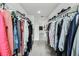 Walk-in closet featuring custom shelving, ample storage space, and carpet flooring at 2350 Gold Dust Dr, Clermont, FL 34715