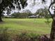 Backyard with ample greenery and a view of the community landscape and neighborhood at 2450 Sweetwater Country Club Dr, Apopka, FL 32712