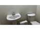 Powder room featuring a pedestal sink and toilet at 2450 Sweetwater Country Club Dr, Apopka, FL 32712