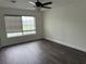 Bedroom showcasing wood-look floors, a ceiling fan, and a window with blinds for natural light at 2450 Sweetwater Country Club Dr, Apopka, FL 32712
