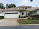 Charming home featuring a two-car garage and a well-maintained landscaped yard at 2450 Sweetwater Country Club Dr, Apopka, FL 32712