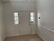 Bright entryway featuring neutral tile flooring and natural light from sidelight windows at 2450 Sweetwater Country Club Dr, Apopka, FL 32712