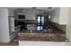 A kitchen area with countertops, white cabinets and tile backsplash at 2450 Sweetwater Country Club Dr, Apopka, FL 32712