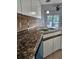 Kitchen with granite countertops, stainless steel sink, and white cabinets at 2450 Sweetwater Country Club Dr, Apopka, FL 32712