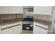 Kitchen featuring stainless steel appliances and white cabinetry at 2450 Sweetwater Country Club Dr, Apopka, FL 32712